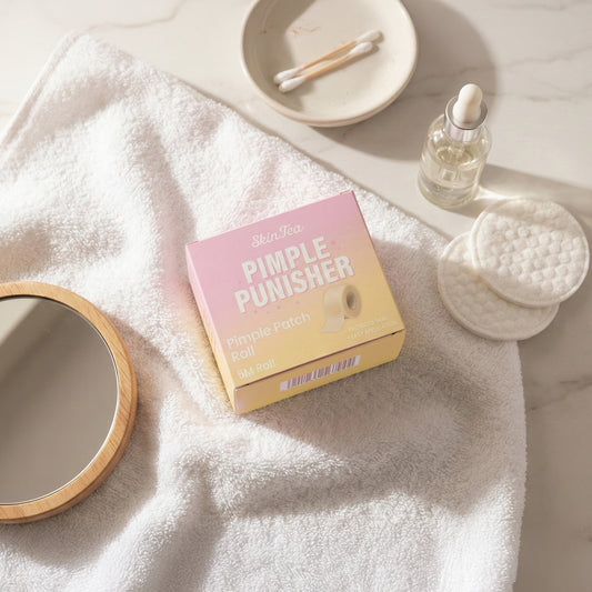 Pink and yellow box labeled 'Pimple Punisher' on a white towel with skincare items.